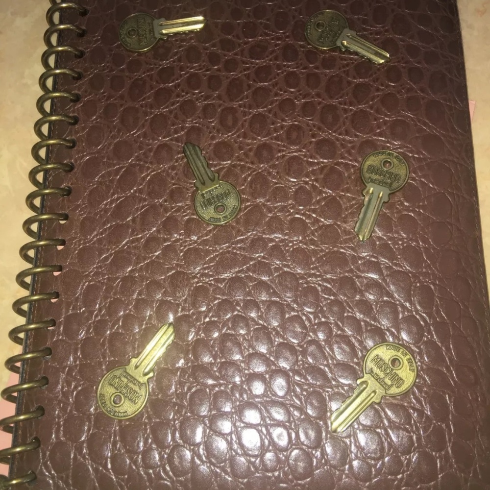 Moschino redwall key studded pocket book